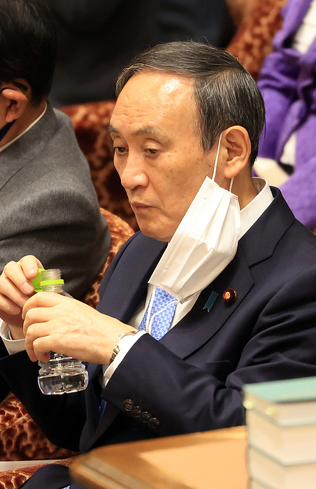 Japanese Prime Minister Yoshihide Suga attends Lower House s budget committee session February 8, 2021, Tokyo, Japan   Japanese Prime Minister Yoshihide Suga drinks water as he listens to a question at Lower House s budget committee session at the National Diet in Tokyo on Monday, February 8, 2021. Suga cabinet s approval rating dived under 40 percent, accoding to a telephone poll.         Photo by Yoshio Tsunoda AFLO 