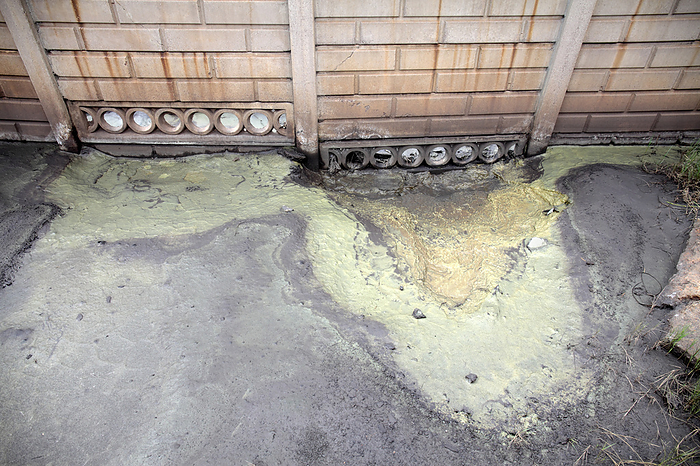 Chemical waste leaking from factory Chemical waste leaking from factory. Close up of chemical waste leaking from an abandoned vanadium processing plant in Witbank, Mpumalanga, South Africa. This waste allegedly contains various toxic heavy metals.