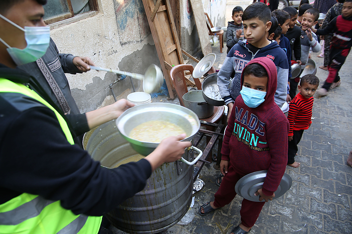Food aid to needy families in Gaza Palestinian volunteer cook distributes food prepared with ingredients obtained from donors, to help needy families in an impoverished neighbourhood in Gaza City, on February 1, 2021.