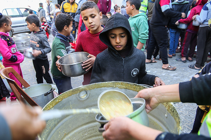 Food aid to needy families in Gaza Palestinian volunteer cook distributes food prepared with ingredients obtained from donors, to help needy families in an impoverished neighbourhood in Gaza City, on February 1, 2021.