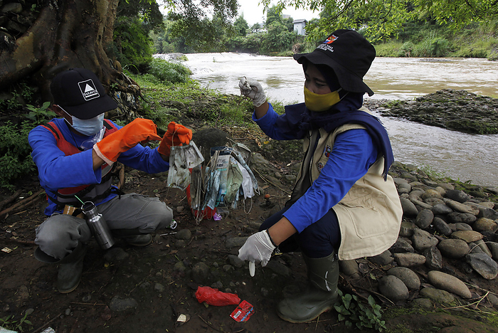 Medical Face Mask Waste in the Ciliwung River, Indonesia Ciliwung naturalization task force collects used medical mask waste, on the banks of the Ciliwung river, Bogor, West Java, February 3, 2021. Medical face mask waste was found along the Ciliwung river which can endanger and pollute the environment.
