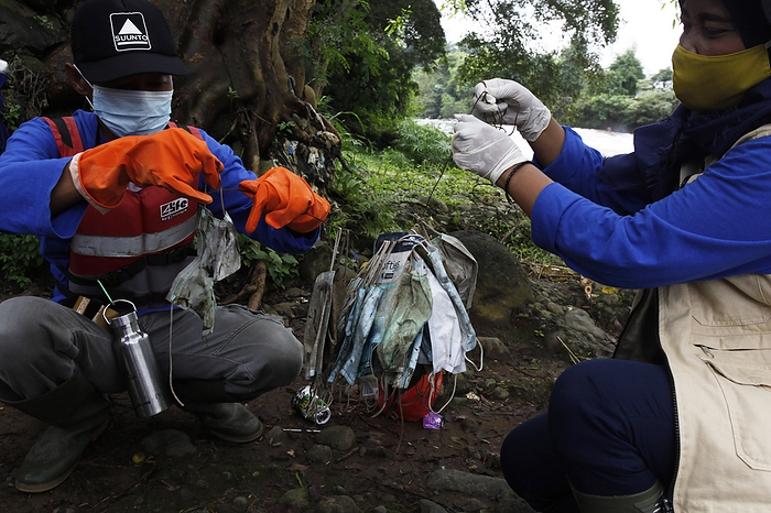 Medical Face Mask Waste in the Ciliwung River, Indonesia Ciliwung naturalization task force collects used medical mask waste, on the banks of the Ciliwung river, Bogor, West Java, February 3, 2021. Medical face mask waste was found along the Ciliwung river which can endanger and pollute the environment.