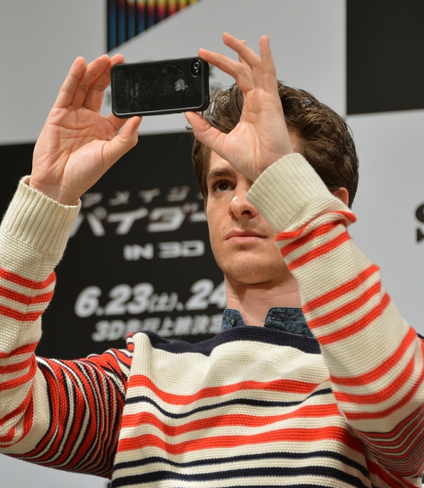 Andrew Garfield, Jun 13, 2012 : Tokyo, Japan - Andrew Garfield snaps shots with his iPhone during a news conference in Tokyo on Wednesday, June 13, 2012. American film star was in town along with director Marc Webb, actress Emma Stone and actor Rhys Ifans to promote the June 23 world premiere of 
