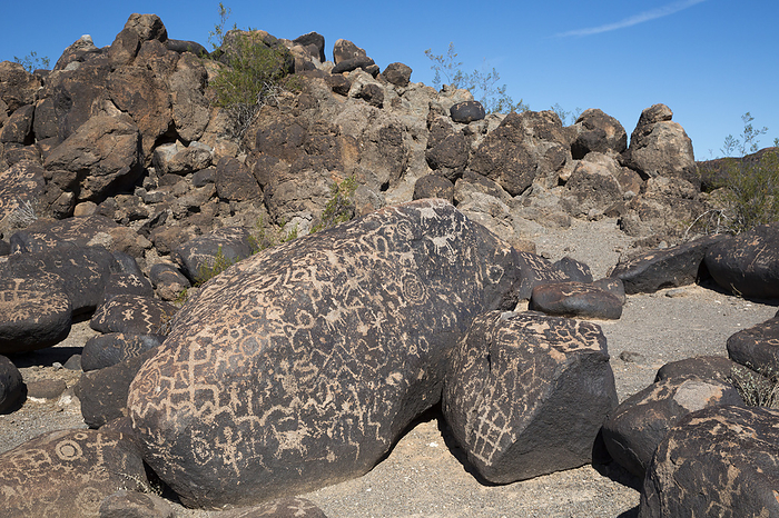 Petroglyphs, Painted Rock, Arizona, USA Rock art. These rock art images  petroglyphs , etched into basalt boulders, were made by the Hohokam, who may be the ancestors of the modern Pima and Tohono O odham peoples in southern Arizona. Photographed at the Painted Rock Petroglyph Site near Gila Bend, Arizona, USA.