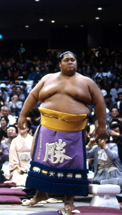Hachijukichi KONISHIKI  1990  Japan: 1990, Tokyo   Konishiki wears an ornamented apron for a ring entry ceremony during a grand sumo tournament in Tokyo in 1990. Born Saleva a Fuauli Atisano e, Konishiki became the first foreign born wrestler ever to reach ozeki, the second highest rank in the sport. His career spanned 15 years from 1982 to 1997. At a peak weight of 287 kg, he was the heaviest rikishi ever in sumo, earning him the nickname  The Dump Truck.   Photo by Fujifotos AFLO  FYJ