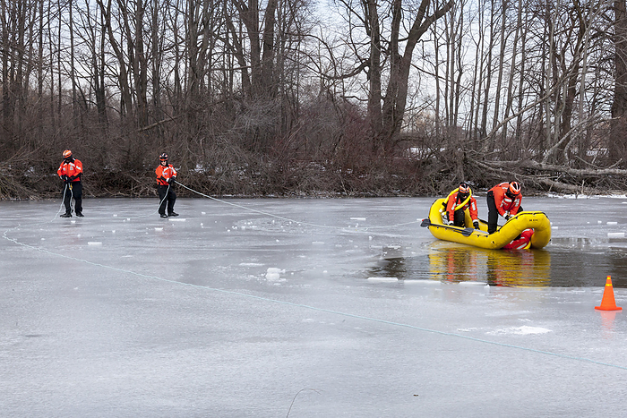 Ice Rescue demonstration Ice Rescue demonstration. A coast guard team demonstrating ice rescue techniques on an ice covered lake. Photographed in Belle Isle State Park, Detroit, Michigan, USA.