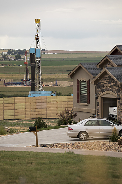 Fracking site near homes, Colorado, USA Fracking site near homes. Fracking rig operating near homes in Berthoud, Colorado, USA. Fracking  hydraulic fracturing  is a technique used to release petroleum and natural gas trapped within rocks. The economic benefits from vast amounts of formerly inaccessible resources are cited by people in favour of fracking. Opponents point to potential environmental impacts, including contamination of ground water and risks to air quality.