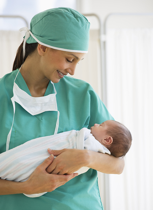 Nurse holding swaddled baby