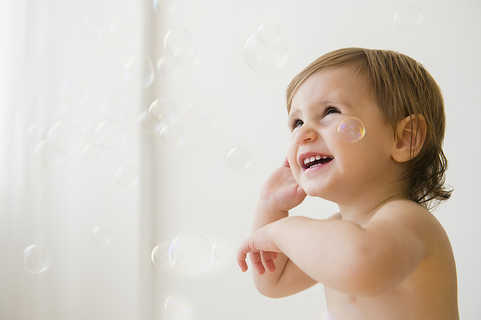 Girl (2-3) playing with bubbles