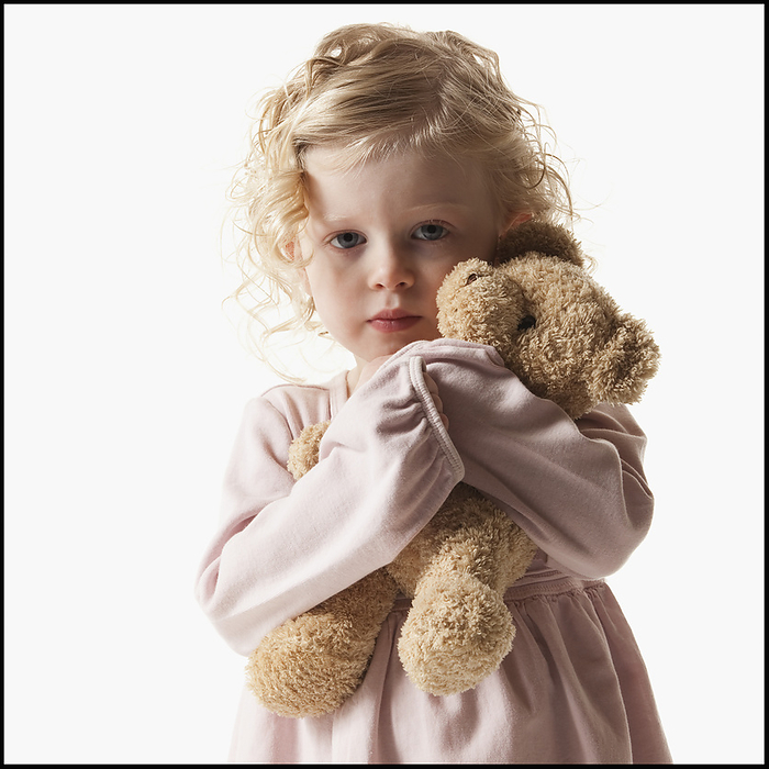 Young girl holding teddy bear