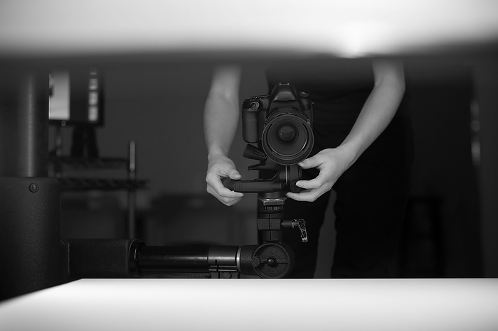 Hand to hold the SLR camera in place