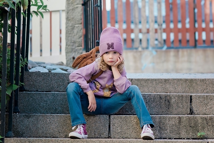 girl portrait of a young girl sat on a step with attitude waiting