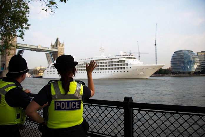 2012 London Olympics Preview Police officers waving to large boats JULY 25, 2012 : police look a cruise ship enter in London through the Tower Bridge, July 25, 2012, London 2012 Olympic Games, London, England,  Photo by Enrico Calderoni AFLO SPORT   0391 
