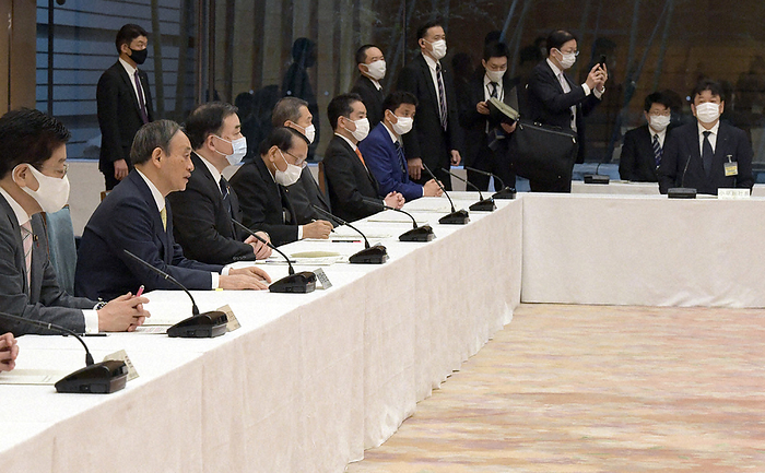 Prime Minister Yoshihide Suga  second from left  speaks at a meeting of ministers and others concerned with decommissioning of TEPCO s Fukushima No. 1 nuclear power plant and measures to deal with contaminated and treated water. The government has decided to discharge the contaminated water into the sea after reducing the concentration of radioactive materials below the government s release standards. On the far right is Tokyo Electric Power Company President Tomoaki Kobayakawa. Prime Minister Yoshihide Suga  second from left  speaks at a meeting of ministers and others concerned with decommissioning of TEPCO s Fukushima No. 1 nuclear power plant and measures to deal with contaminated and treated water. The government has decided to discharge the contaminated water into the sea after lowering the concentration of radioactive materials below the government s release standards. On the far right is Tokyo Electric Power Company President Tomoaki Kobayakawa, photographed at the prime minister s official residence at 8:07 a.m. on April 13, 2021.