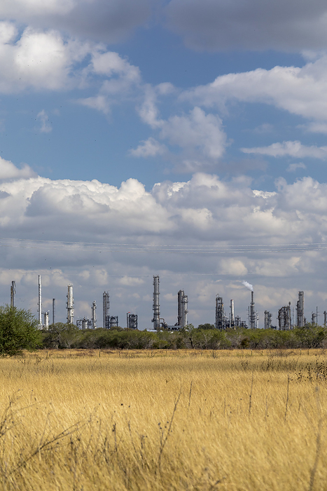 Valero Oil Refinery, Texas, USA Valero Oil Refinery. View across a field towards the Valero Oil Refinery, Three Rivers, Texas, USA. This oil refinery mainly processes crude oil extracted from the surrounding Eagle Ford Shale.