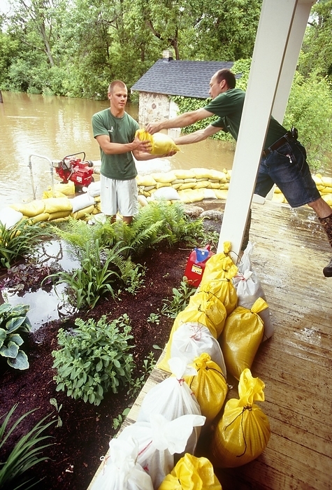 Flood barriers, Wisconsin Flood barriers. Residents stacking sandbags in front of their home to protect it from flooding. In June 2008, much of the American Midwest had heavy rainfall and severe flooding, which caused 24 deaths and over 35,000 people to be evacuated from their homes. Photographed in Thiensville, Wisconsin, USA.