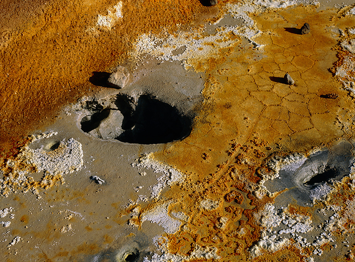 Boiling volcanic mudpot holes, Iceland Detail of boiling mudpot holes at a geothermal area on the side of the Leirhnjukur volcano, Iceland. The ground is coloured yellow by sulphur deposits.