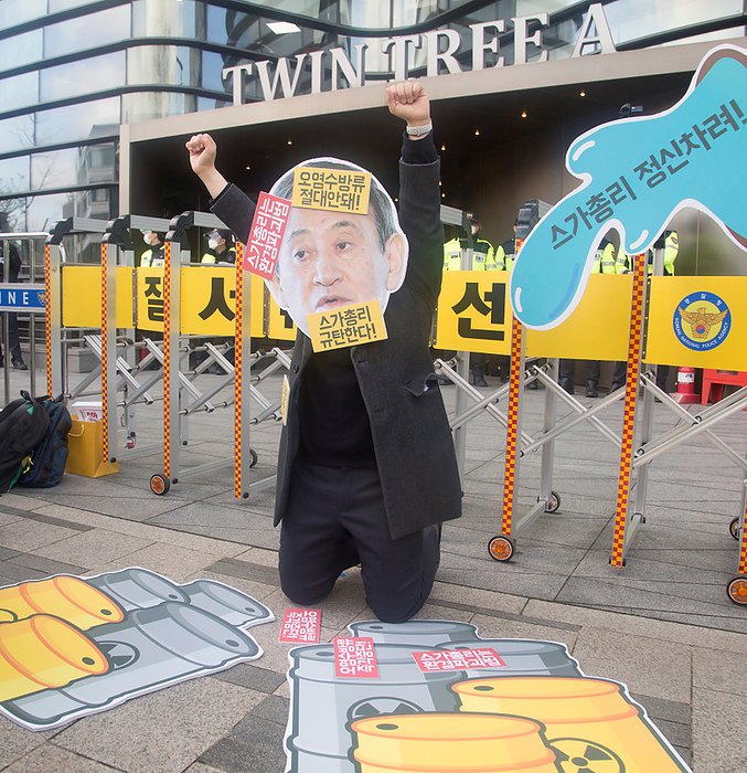 Activists in Seoul protest against Japan s decision to discharge radioactive water from Fukushima. Protest against Japan s decision to release water from Fukushima, Apr 13, 2021 : A South Korean activist wearing a cutout depicting Japanese Prime Minister Yoshihide Suga attends a protest against the Japanese government s decision to discharge radioactive water from Fukushima Daiichi Nuclear Power Plant in Japan, in front of the Japanese Embassy in Seoul, South Korea. Korean characters on the cutout  L R  read, Japanese Prime Minister Yoshihide Suga is an environmental offender ,  You should never discharge contaminated water   and  We condemn Japanese Prime Minister Yoshihide Suga  .  Photo by Lee Jae Won AFLO   SOUTH KOREA 