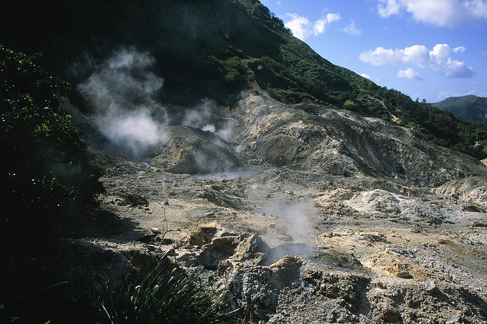 Volcanic mud pools Volcanic mud pools. Steam rising from the Qualibu   place of death   volcano on the Caribbean island of St Lucia. It is also called the  Drive In   volcano because it is accessible by road. It is actually the remains of a volcano that collapsed 39,000 years ago, leaving boiling mud pools and a heavy smell of sulphur. St Lucia is part of the Lesser Antilles, which is a group of volcanic islands at the south eastern edge of the Caribbean Sea. This volcano is near the village of Soufriere. The name  soufriere  refers to the sulphur fumes produced by volcanic activity. 