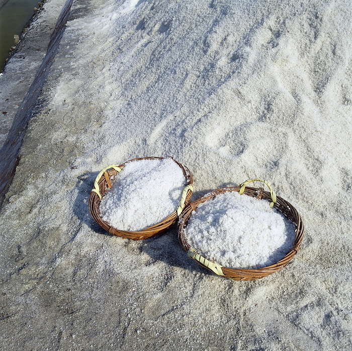 Salt extraction Salt extraction. Baskets containing salt extracted from a salt pan. Salt is produced by allowing seawater to evaporate from shallow areas. The mineral salt deposits left behind are collected and sold. Photographed at the Szutsao salt fields in Taiwan.