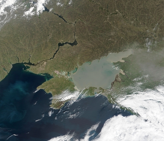 Eutrophication in the Sea of Azov Eutrophication. True colour satellite image of discolouration of the Sea of Azov  grey brown, centre , Ukraine, due to eutrophication. North is at top. Water is blue, vegetation is green, clouds are white. The Sea of Azov, connected to the Black Sea  lower left , is mostly freshwater. The River Dnieper is at upper left. Eutrophication is the excessive influx of agricultural fertilisers that causes algal blooms  excessive algal growth  that can devastate lake and river ecosystems. Silt and sediment deposits are also problems in the Sea of Azov. Image taken on 21 March 2002 by the Moderate Resolution Imaging Spectroradiometer  MODIS  aboard NASA s Terra satellite.