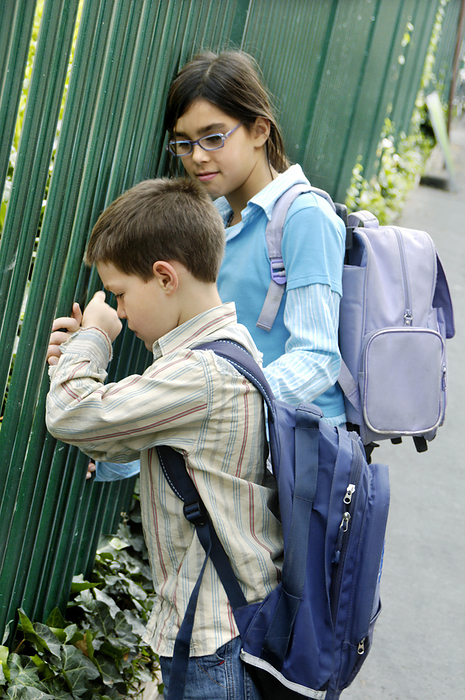 Girl comforting an unhappy boy MODEL RELEASED. Girl comforting an unhappy boy who s scared about going to school.