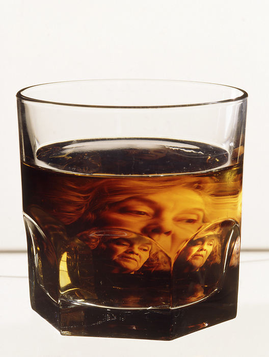 Glass of alcohol with image of alcoholic woman Alcohol addiction. Glass of alcohol, with an abstract image of a woman reflected in the liquid. In her expression, the woman appears to be struggling with her addiction. Alcohol is an addictive substance which acts as a depressant on the nervous system, and so reduces anxiety, tension and inhibitions. Dependency on alcohol  alcoholism  is an illness which leads to withdrawal symptoms when drinking is suddenly stopped. Long term and excessive alcohol consumption may cause irreversible damage to the heart, liver, brain and nervous system.
