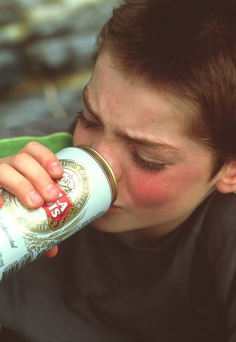 Underage drinking Underage drinking. 11 year old boy drinking from a beer can.