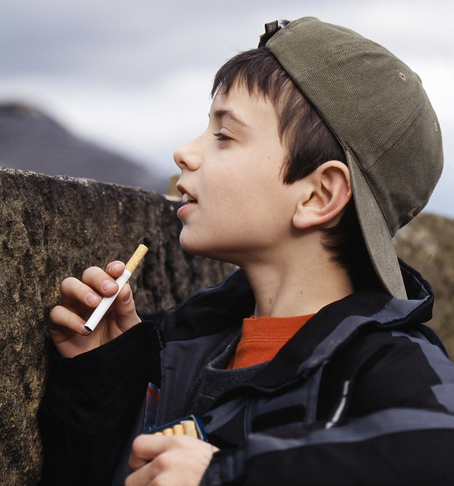 Boy with cigarettes Boy with cigarettes peering over a wall. Many children try smoking due to curiosity and a desire to experiment, but most children who continue to smoke do so because their friends also smoke. This pressure to act like your friends is called peer pressure. Some people become addicted to the drug nicotine that is contained in tobacco cigarettes. Cigarettes also contain cancer causing chemicals. Tobacco smoking is a major cause of lung cancer and chronic bronchitis.