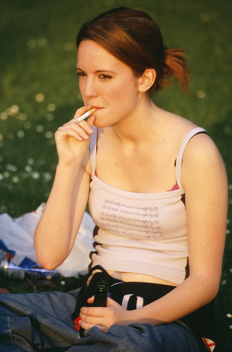 Teenage girl smoking Teenage girl smoking and drinking with friends. The influence of friends is the main reason teenagers start smoking and drinking. Both are an aquired taste, but over 80  of those who start smoking in their teens become permanently hooked.