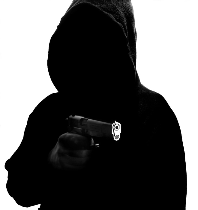 Gun crime MODEL RELEASED. Gun crime. Hooded youth aiming a gun.