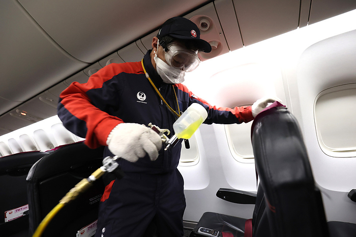 Japan Airlines  JAL  workers disinfect their aircraft cabin to protect from the coronavirus April 23, 2021, Tokyo, Japan   A worker of Japan Airlines  JAL  sprays anti virus and anti bacteria agent to the passenger seats and aircraft cabin including toilets at a hanger of JAL at the Haneda airport in Tokyo on Friday, April 23, 2021. Japan s airlines are struggling their business since the government will declare the COVID 19 state of emergency on Tokyo, Osaka, Kyoto and Hyogo prefecture during the Golden Week holidays.     Photo by Yoshio Tsunoda AFLO  