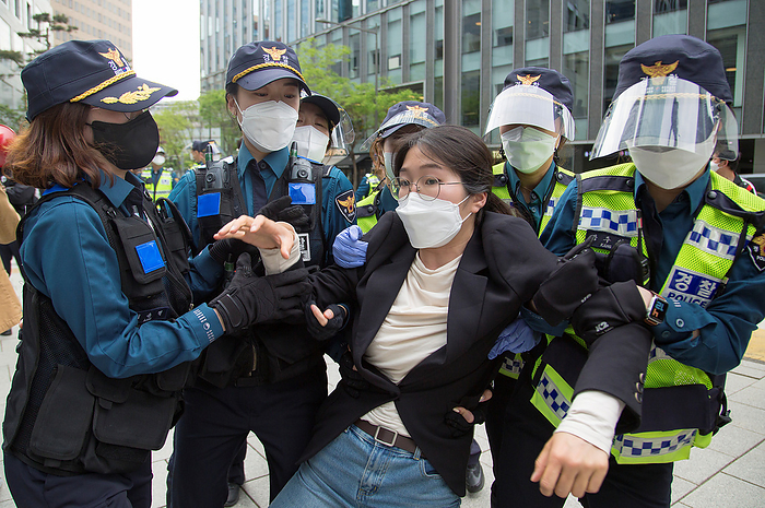 Contaminated Water Treatment at Fukushima Daiichi Nuclear Power Plant: South Korea Protests Release of Treated Water into the Pacific Ocean. Protest against Japan to release water contaminated with radioactive material from Fukushima, Apr 24, 2021 : Policewomen detain a student protester during an anti Japan protest near the Japanese Embassy in Seoul, South Korea. Japan recently decided to start discharging the tritium laced water from the destroyed Fukushima nuclear power plant into the Pacific Ocean in 2023 in what is expected to be a decadeslong process despite opposition from neighboring countries including South Korea.  Photo by Lee Jae Won AFLO   SOUTH KOREA 