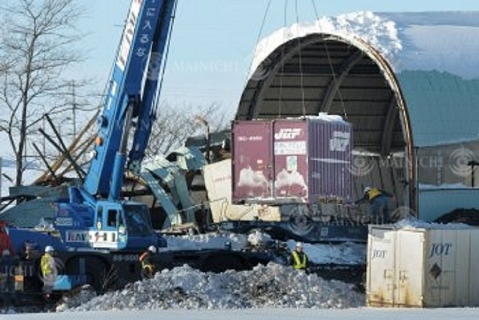 Container being lifted by crane from derailed freight car on JR Ishikatsu Line, Hokkaido, Japan. Containers being lifted by crane from derailed freight car in Anpei Town, Hokkaido, Japan, afternoon, February 18, 2012. Photo by Maiko Umeda at 3:46 p.m.