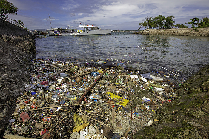 A harbor in Cebu filled with plastic floating trash, Philippines., Photo by David Fleetham