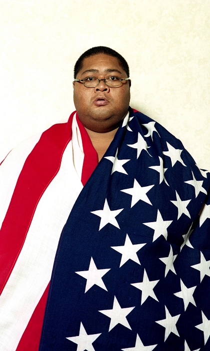Hachijukichi Konishiki  June 1999  Japan: June 1999, Tokyo   Former sumo wrestler Konishiki, draping the Stars and Stripes over his body, poses for pictures.  Photo by Fujifotos AFLO  FYJ
