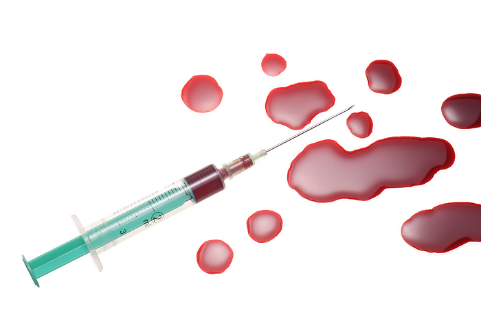 Hypodermic needle and spilt blood Hypodermic needle and spilt blood.