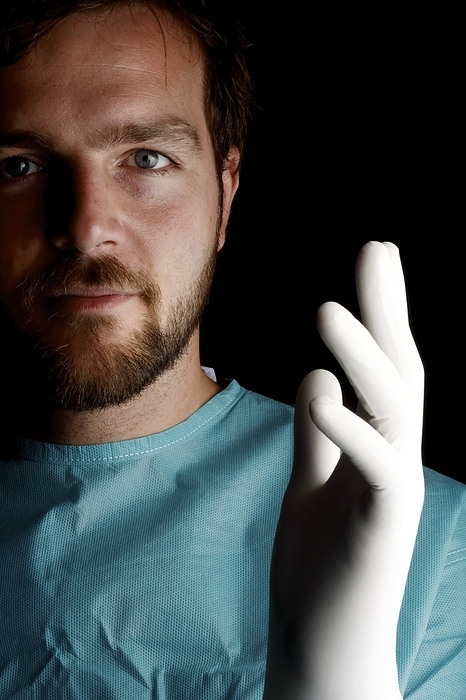 Pathologist Pathologist holding up a gloved hand.