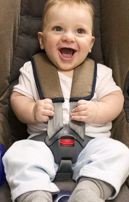 Child s car seat MODEL RELEASED. Child s car seat. Smiling eight and a half month old baby boy strapped into a child s car seat.