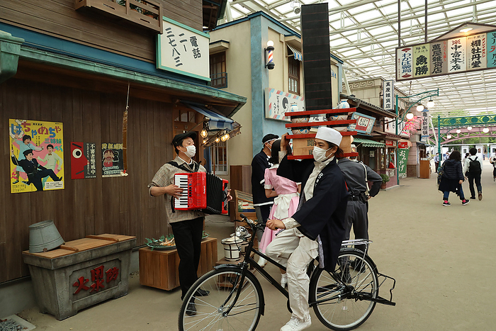 Seibuen amusement park is fully renovated and will reopen with the new attractions May 18, 2021, Tokorozawa, Japan   An actor performs as a delivery man of a noodle shop at the renovated Seibuen amusement park which has the  Showa Retro , post WWII period atmosphere shopping arcade at a press preview in Tokorozawa, suburban Tokyo on Tuesday, May 18, 2021. Seibuen amusement park, closed temporarily last year for fully renovation, will reopen on May 19 with the new attractions.      Photo by Yoshio Tsunoda AFLO  