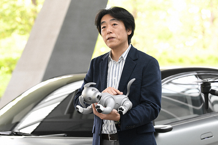 Izumi Kawanishi of Sony Corporation answers an interview. The  aibo  in his arms. Izumi Kawanishi of Sony Corporation answers an interview. The  aibo  held in his arms is Emi Naito, photographed on April 22, 2021 in Minato ku, Tokyo.