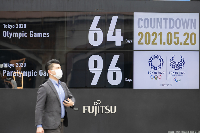 Two months until the Tokyo Olympics,the state of emergency contiues Display in front of Shinbashi station.   Nearly 70  of Japanese firms want the Tokyo Olympics either cancelled or postponed, a Reuters survey found, underscoring concerns that the Games will increase coronavirus infections at a time when the medical system is under heavy strain. With just nine weeks to go before the Games, states of emergency have been imposed in much of Japan until the end of the month to counter a spike in infections that has resulted in a shortage of medical staff and hospital beds in some areas.  The country s vaccination programme has also been particularly slow, with just 4  of the population inoculated, the lowest rate among the Group of Seven nations.