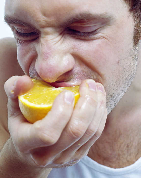 Man eating orange Man eating orange. Man biting into a juicy orange  Citrus sinensis . The orange is a rich source of vitamin C  ascorbic acid . This is needed to build and maintain healthy bones, teeth, gums and blood vessels, as well as helping some of the body s enzymes to work properly.