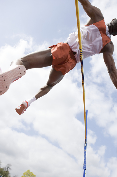 Athlete performing a high jump MODEL RELEASED. Athlete performing a high jump. This is a track and field event in which athletes must jump over a horizontal bar placed at measured heights.