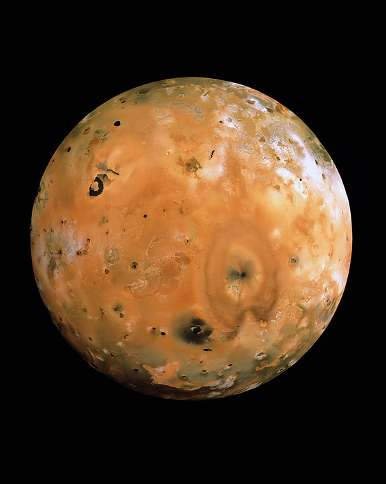 Jupiter s moon Io Io. Hemisphere view of Io, one of the four Galilean moons of Jupiter. The strong orange colour comes from sulphur compounds which cover the surface. Io is the most active body in the solar system, and is dotted with volcanoes such as Pele  heart shaped feature right of centre  and Loki  next to black horseshoe shaped lava lake, upper left . Gravitational tidal forces pull at Io so much that enormous heat is generated in the interior. The heated rock rises through strata containing sulphur and sulphur dioxide, causing them to erupt like a geyser. White patches are probably solid sulphur dioxide frost. The data for this image were gathered by Voyager spacecraft.