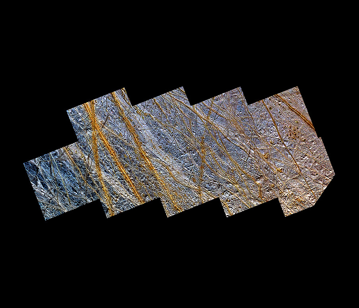 Europa s surface Europa. Enhanced colour Galileo orbiter image of part of the northern hemisphere of Europa, a moon of Jupiter. North is at lower left. The surface of Europa is covered in water ice  blue white . Cutt  ing through the ice are ridges  brown orange  that may be the result of cryovolcanic activity as erupted water or partially molten water ice froze on the cold surface. Their colour may be due to them containing evaporites such as mineral salts. This view was produced from a high resolution image taken on 31 May 1998 and a low resolution image taken on 28 June 1996 by Galileo s Solid State Imaging  SSI  camera. It has an area of about 800x350 km and a resolution of 230 metres.