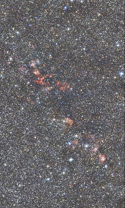Star forming regions Star forming regions. Coloured infrared image showing the chain of star forming regions collectively known as W51. These reddish areas are made of compact and extended HII regions and molecular clouds. Stars in the centres of these regions are typically young and massive, in spectral class O and B, and radiation from them is responsible for ionising hydrogen surrounding them. W51 is in the Sagittarius arm of the galaxy at a distance of about 24,000 light years from Earth. This image was made as part of the Two  Micron All Sky Survey  2MASS  project.