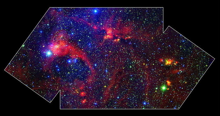 Massive stars forming in DR21 Massive stars forming in nebula DR21, Spitzer Space Telescope image. DR21 is a region  centre, top  about 10,000 light years away in the constellation Cygnus. It is a bright source of radio emission, but heavy dust obscures all its light. Infrared cameras on Spitzer penetrate this, revealing a stellar nursery for stars up to 100,000 times as bright as the sun. There is a gaseous outflow from DR21  green . The red filaments in the image glow because of polycyclic aromatic hydrocarbons  PAHs , which are excited into luminescence by radiation at wavelengths near 8 microns. Blue represents wavelengths of 3.6 microns, rising through green and orange to red at 8 microns.