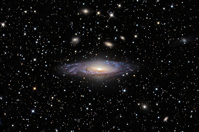 Spiral galaxy NGC 7331 Spiral galaxy NGC 7331, optical image. This galaxy has a number of large starbirth regions  pink  in its spiral arms, areas where new stars are being formed. Hot young stars are bluer than older stars, hence the arms generally appear blue. Older stars and dust at the centre of the galaxy contribute to its yellower appearance. NGC 7331 lies around 43 million light years from Earth in the constellation Pegasus.