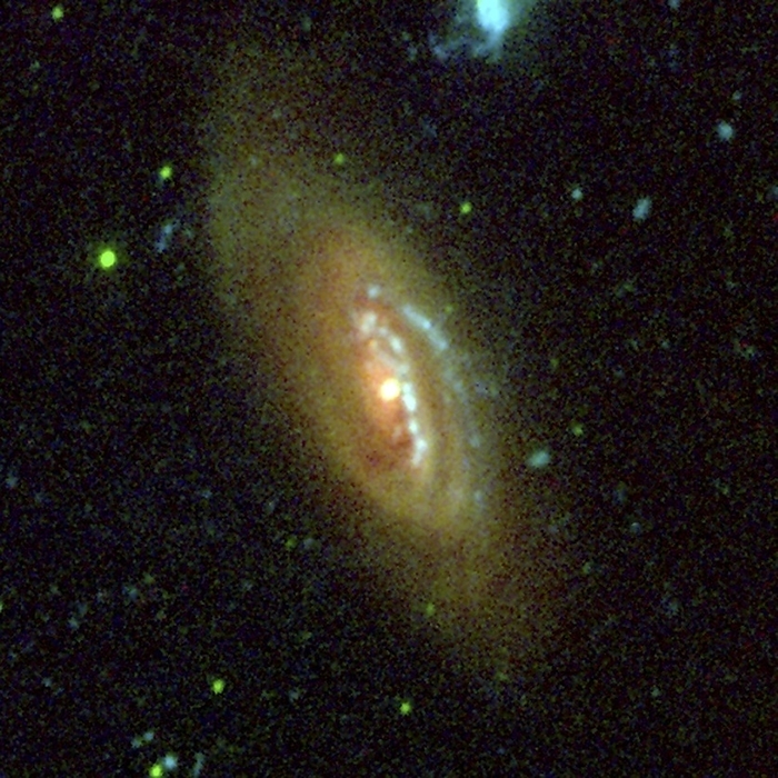 Spiral galaxy NGC 300, composite image Spiral galaxy M90. Ultraviolet  green  and visible light  red  composite image of the spiral galaxy M90, which is also known as NGC 4569. This galaxy is located about 60 million light years away from Earth, in the constellation Virgo. Image obtained using the Galaxy Evolution Explorer  GALEX  Orbiter telescope and the 1.5 meter telescope at Palomar Observatory, USA.